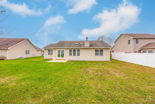 rear view of property featuring a lawn and a patio area