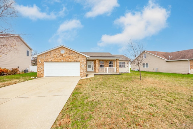 ranch-style home with covered porch, a garage, and a front yard