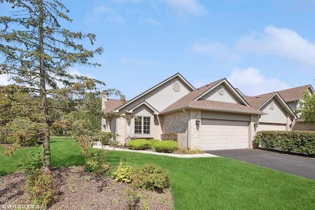 view of front of house with a garage and a front yard