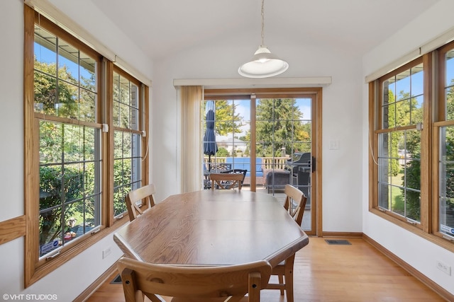 dining area featuring light hardwood / wood-style flooring and vaulted ceiling