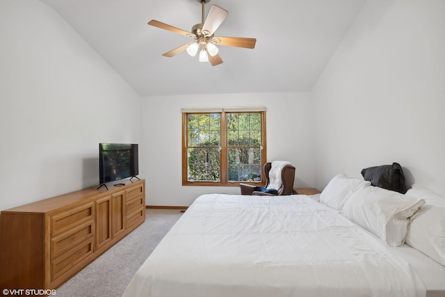 bedroom with light carpet, vaulted ceiling, and ceiling fan