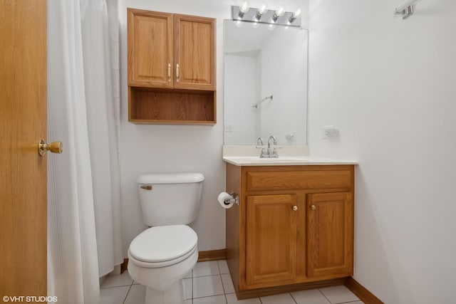 bathroom featuring tile patterned flooring, vanity, and toilet