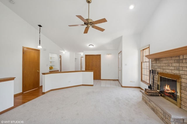 unfurnished living room featuring light carpet, ceiling fan, lofted ceiling, and a brick fireplace