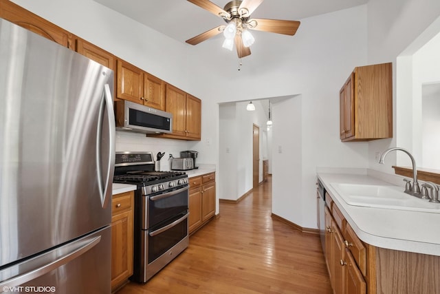 kitchen featuring ceiling fan, light hardwood / wood-style floors, sink, and appliances with stainless steel finishes