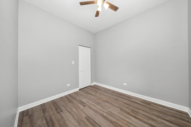 empty room with dark hardwood / wood-style floors and ceiling fan