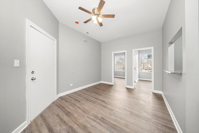 unfurnished room with ceiling fan and wood-type flooring