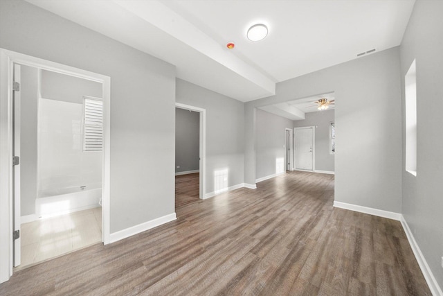 unfurnished living room with ceiling fan and hardwood / wood-style flooring