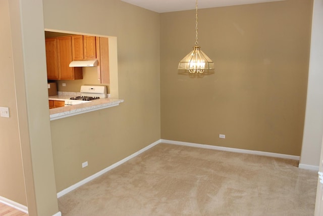 unfurnished dining area featuring light colored carpet and a notable chandelier