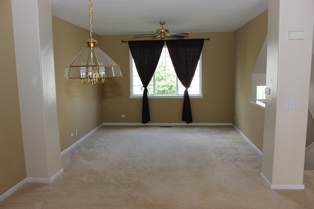 empty room featuring light carpet and ceiling fan with notable chandelier