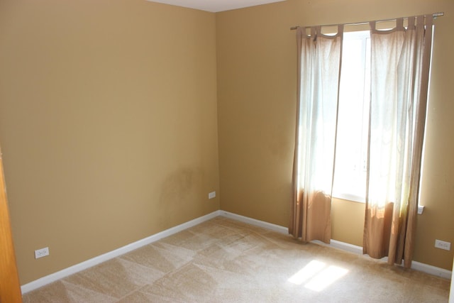 unfurnished room with light colored carpet