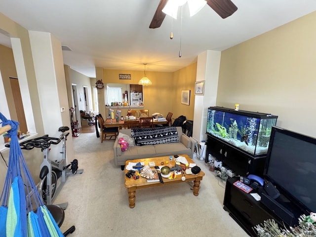 living room with ceiling fan and carpet floors