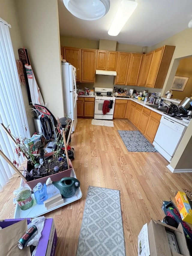 kitchen with white appliances and light wood-type flooring