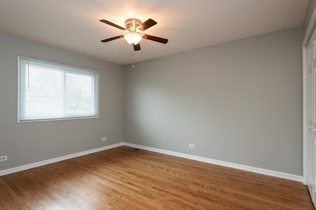 empty room with hardwood / wood-style flooring and ceiling fan