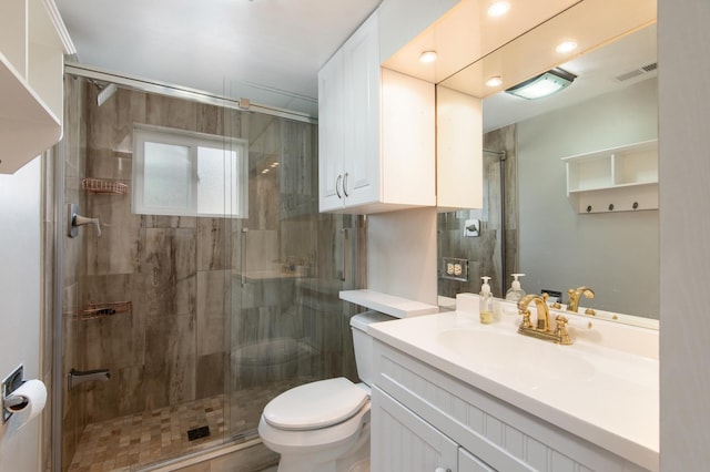 bathroom featuring walk in shower, vanity, and toilet