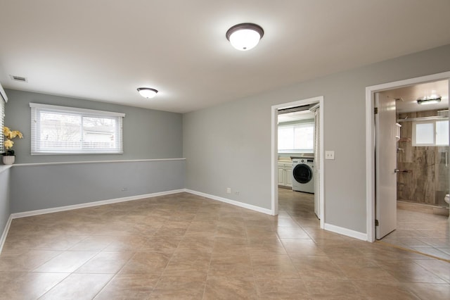 tiled spare room featuring washer / clothes dryer