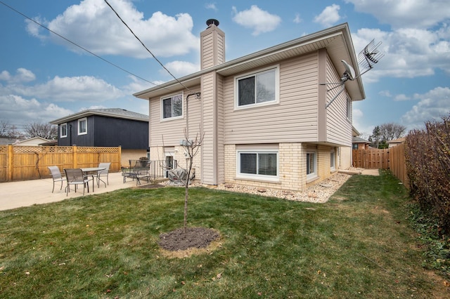 rear view of property with a yard and a patio area