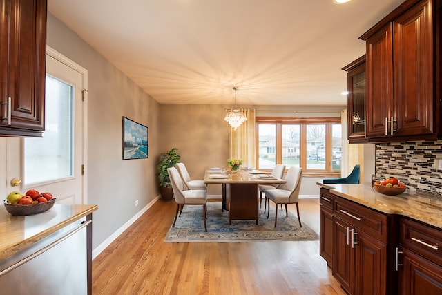 dining area featuring light hardwood / wood-style floors and an inviting chandelier