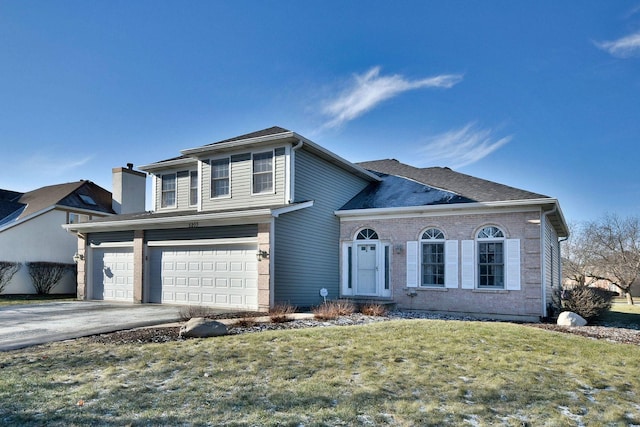 view of property with a front lawn and a garage