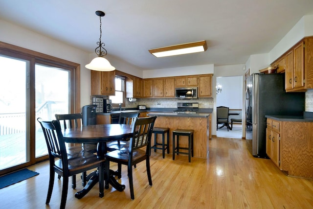 dining space with light hardwood / wood-style flooring