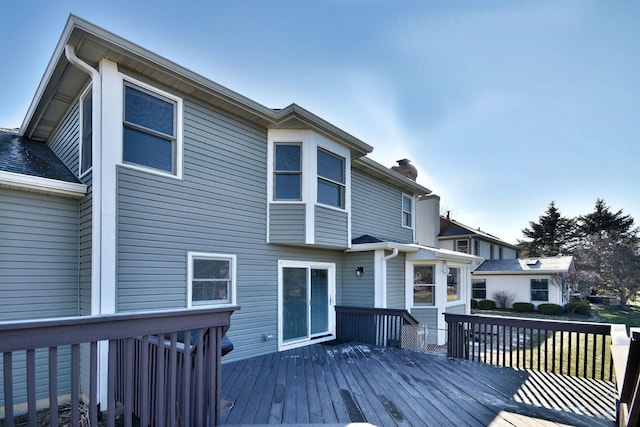 rear view of house featuring a wooden deck