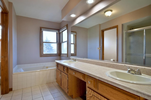 bathroom with tile patterned flooring, shower with separate bathtub, and vanity