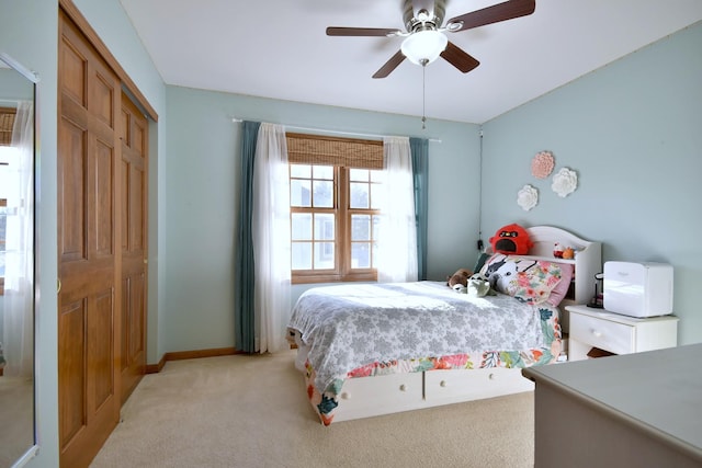 bedroom featuring light carpet, a closet, and ceiling fan