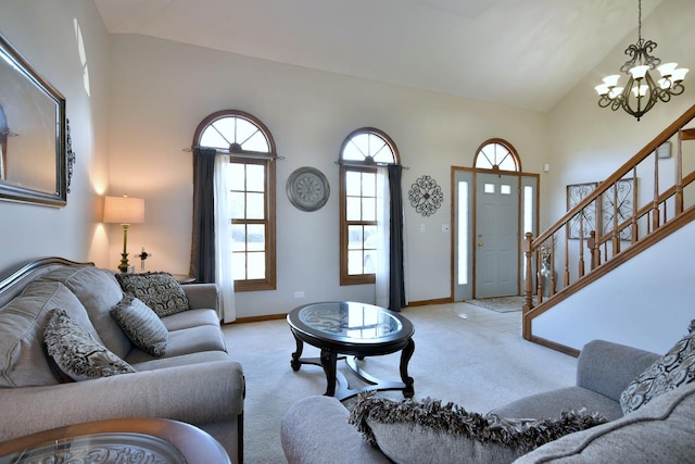 living room with light carpet, high vaulted ceiling, and an inviting chandelier