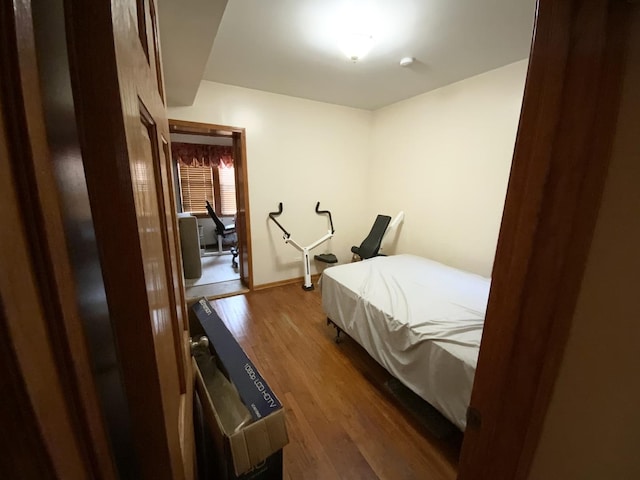 bedroom with dark hardwood / wood-style flooring