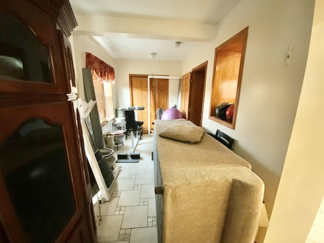 bedroom with beamed ceiling and a closet