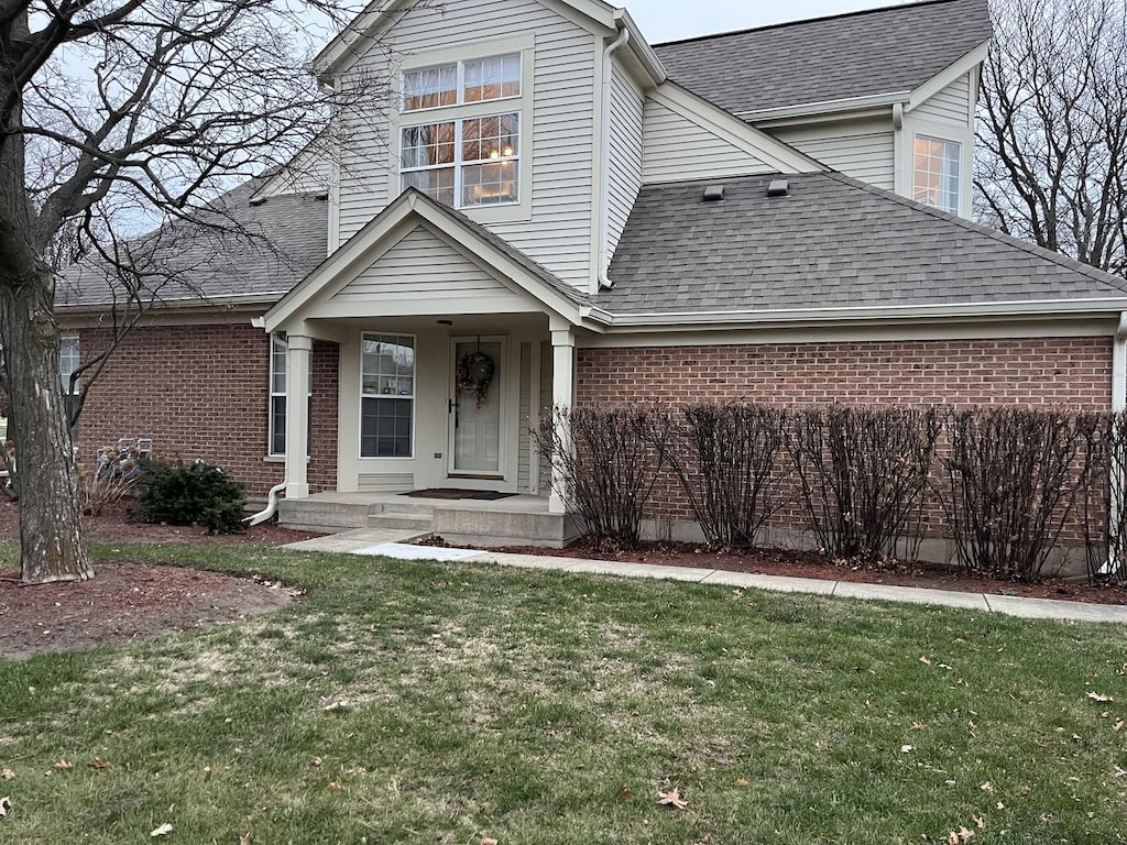 view of property featuring a front lawn