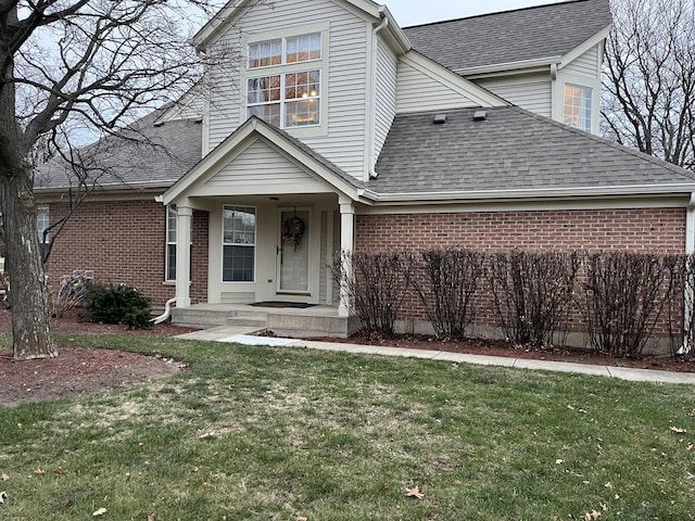 view of property featuring a front lawn