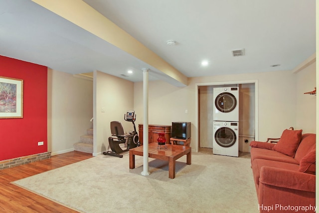 interior space featuring hardwood / wood-style flooring and stacked washing maching and dryer