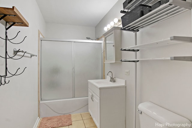 full bathroom with tile patterned flooring, vanity, toilet, and bath / shower combo with glass door