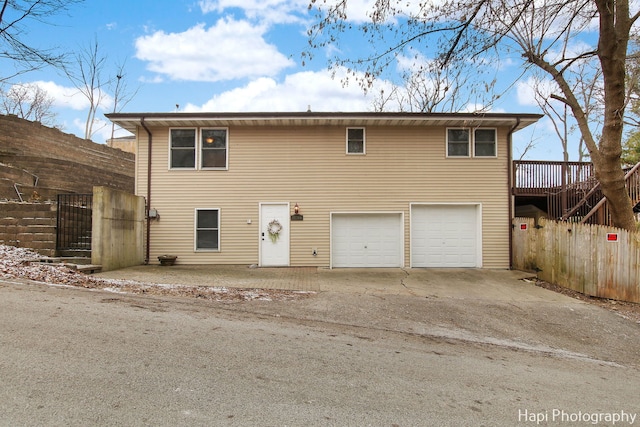 view of front facade with a garage and a deck