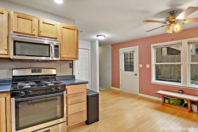 kitchen with ceiling fan, light wood-type flooring, stainless steel appliances, and light brown cabinetry