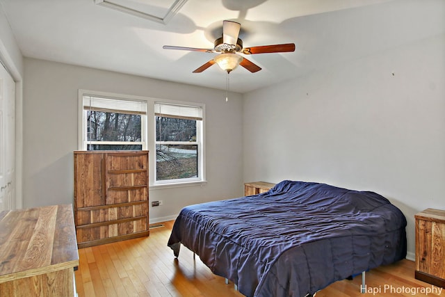 bedroom with ceiling fan, a closet, and light hardwood / wood-style flooring