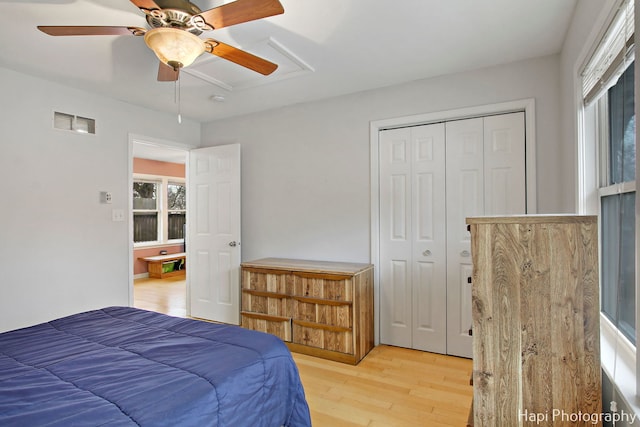 bedroom featuring hardwood / wood-style floors, a closet, and ceiling fan