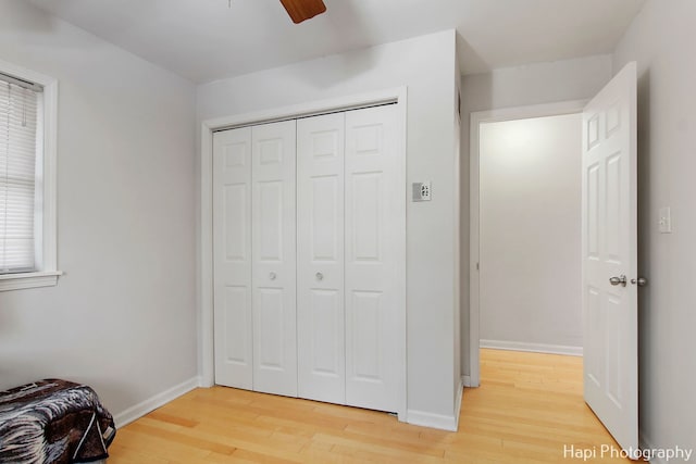 bedroom featuring hardwood / wood-style floors, a closet, and ceiling fan