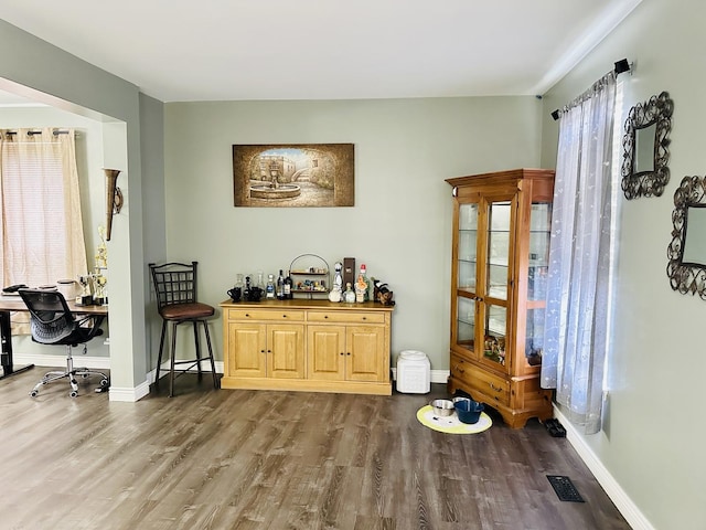 bar featuring hardwood / wood-style flooring