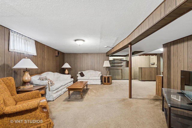 living room with a textured ceiling, wood walls, and light carpet