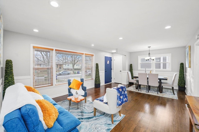 living room with dark hardwood / wood-style floors and a chandelier