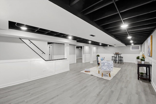 basement with light hardwood / wood-style floors