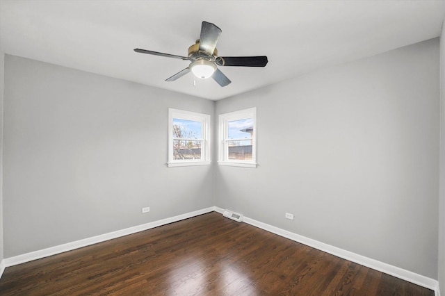 empty room featuring dark hardwood / wood-style floors and ceiling fan