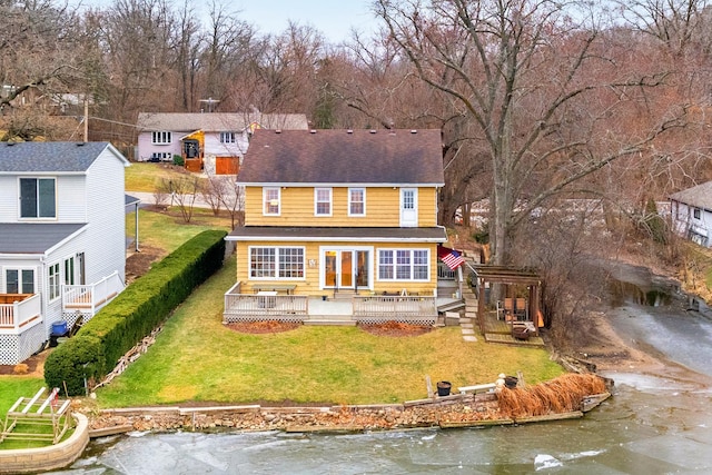 back of property featuring a deck with water view, a yard, and a pergola