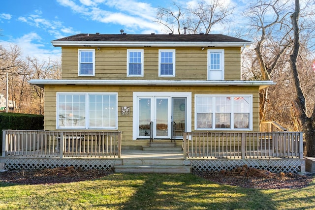 view of front of home with a front lawn and a deck