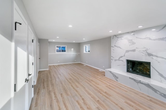 7S135 Clover Ct, Naperville, IL 60540 - unfurnished living room featuring recessed lighting, a large fireplace, light wood finished floors, and baseboards