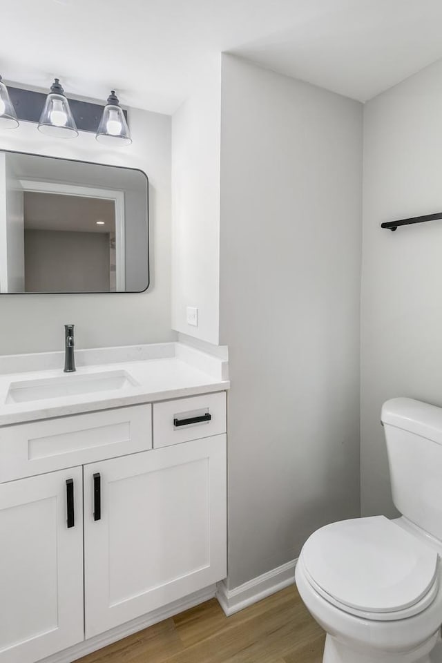 7S135 Clover Ct, Naperville, IL 60540 - bathroom with toilet, vanity, wood finished floors, and baseboards