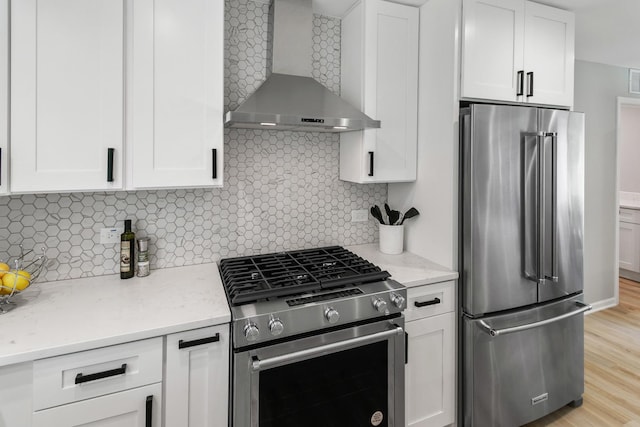 7S135 Clover Ct, Naperville, IL 60540 - kitchen with stainless steel appliances, wall chimney exhaust hood, white cabinetry, decorative backsplash, and light stone countertops