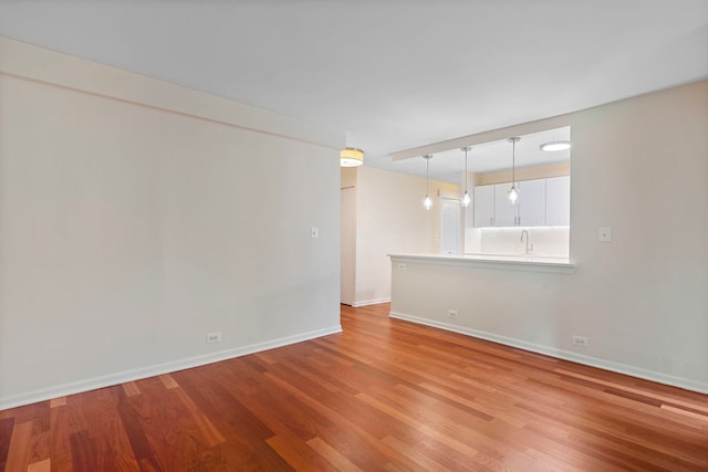 spare room with light wood-type flooring and sink