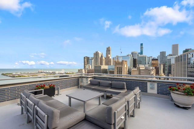 view of patio / terrace with a balcony, a water view, and an outdoor hangout area